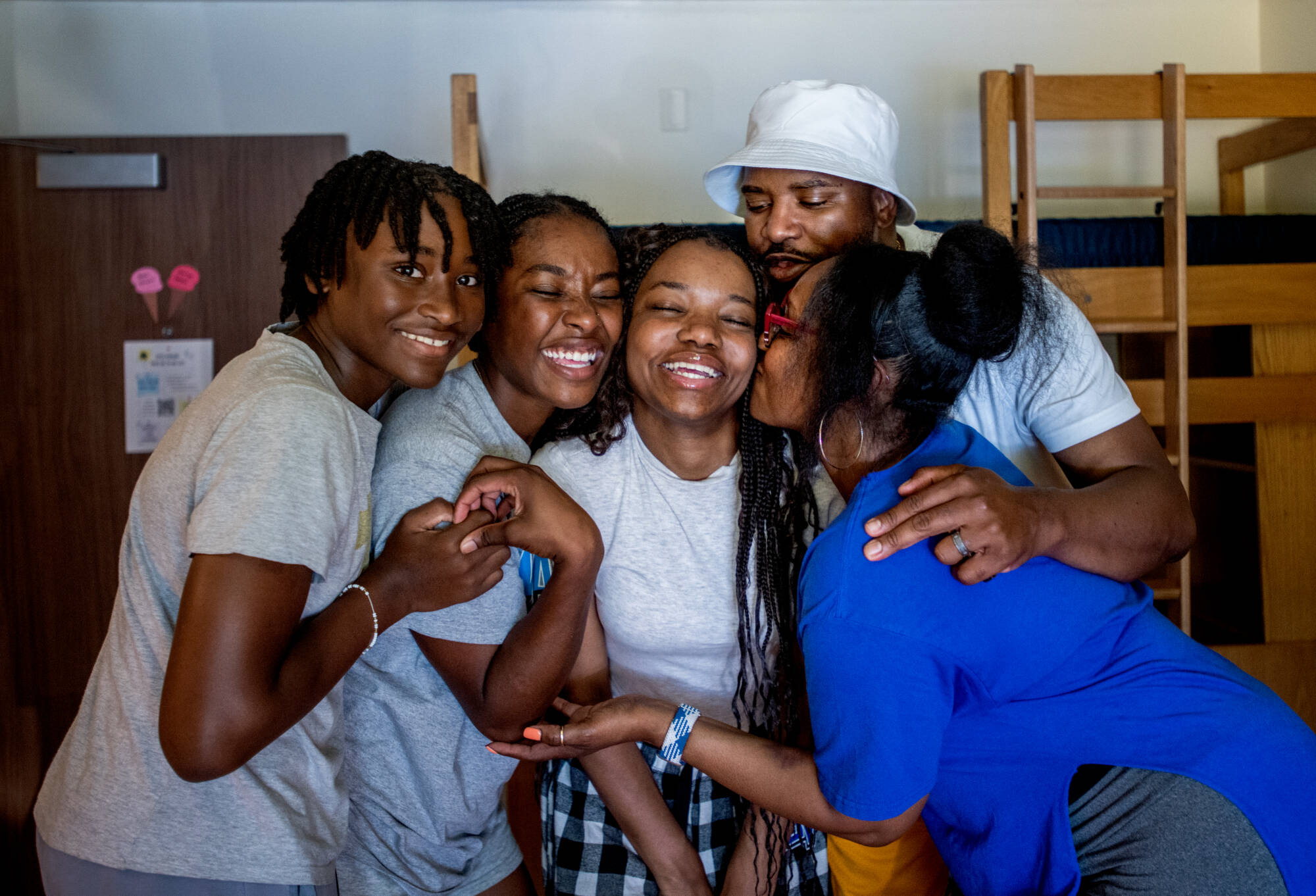 Family embraces in a hug during move-in.